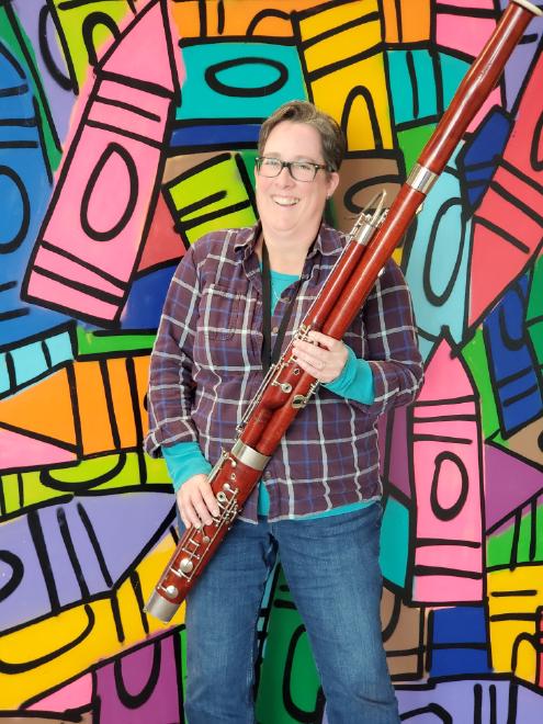 Amber Ferenz holding bassoon with colorful crayon background